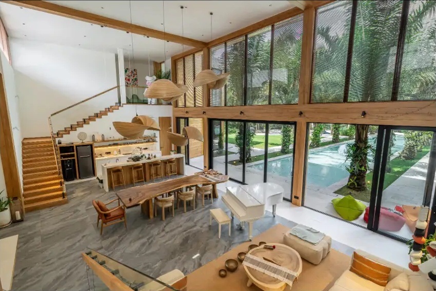 Light-filled villa living and dining area opening onto the tropical garden